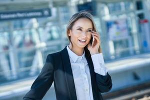 Adult female passenger using smartphone at the airport photo