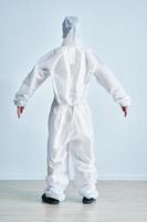 Woman in bio-hazard suit on white background. photo