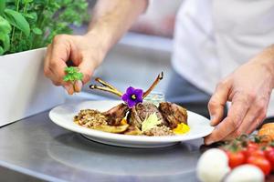 Busy chef at work in the restaurant kitchen photo