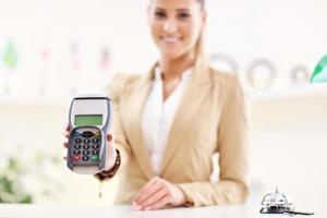 Happy receptionist working in hotel photo