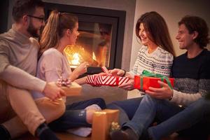 Group of friends with presents celebrating Christmas at home photo