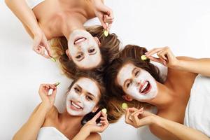 Three friends with facial masks photo