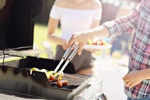 Friends having barbecue party in backyard photo