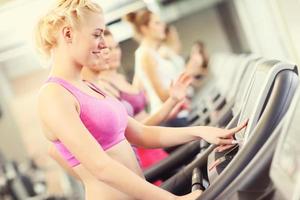 Group of women jogging on treadmill photo