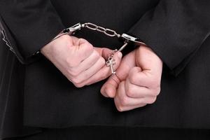 Man in suit handcuffed photo