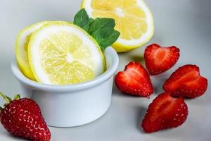 Lemon, mint and strawberries. photo