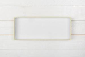 White rectangular empty open box, top view on white wooden background. top view photo