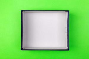 Empty box for product on green background. top view photo