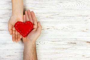 help, Heart in Hand on wood background. Valentine day concept. copy space