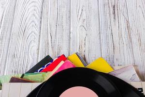 Vinyl records and headphones on table. Vintage vinyl disk photo