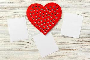 Valentine's Day, Valentine's Day. Hearts and empty frame on a stone black background. top veiw photo