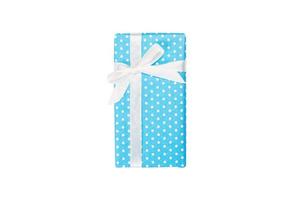 Christmas or other holiday handmade present in blue paper with white ribbon. Isolated on white background, top view. thanksgiving Gift box concept photo