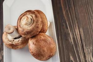 Portobello mushrooms on white plate in home kitchen photo