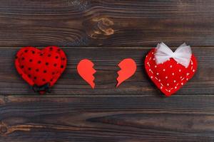 Broken heart on rustic wooden table background photo