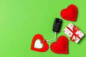 Top view of car key, gift boxes and toy hearts on colorful background. Saint Valentine's Day concept with copy space photo