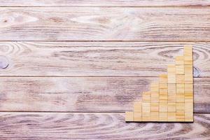 A wooden blocks cube over black wooden textured background with copy space for add word text title. Concept or conceptual Wood block stair or eight steps. Cubic photo