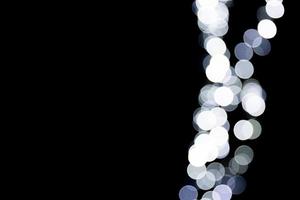 Abstract bokeh of white city lights on black background. defocused and blurred many round light photo