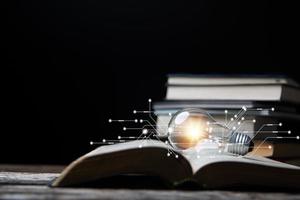 Light bulbs and books. Concept of reading books, knowledge, and searching for new ideas. Innovation and inspiration, Creativity with twinkling lights, the inspiration of ideas. photo