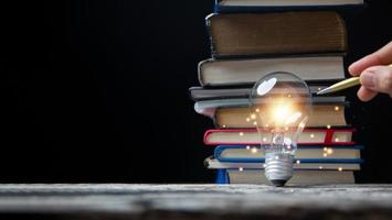 Light bulbs and books. Concept of reading books, knowledge, and searching for new ideas. Innovation and inspiration, Creativity with twinkling lights, the inspiration of ideas. photo