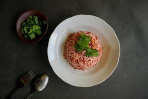 Red steamed rice or nasi merah served in plate isolated on black background photo