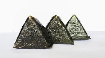 Onigiri is Japanese food, Japanese rice ball, rice triangle with seaweed, nori isolated on with background photo