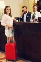 Woman at reception desk in hotel photo