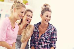 Three beautiful young women chilling at home photo