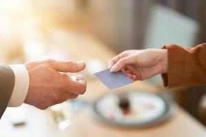 Closeup portrait of two successful business executive exchanging business card photo