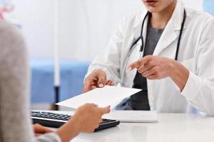 Adult woman having a visit at female doctor's office photo