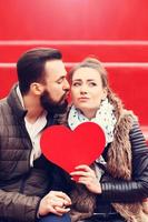 Romantic couple holding heart photo
