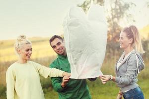 Group of friends floating chinese lanterns photo