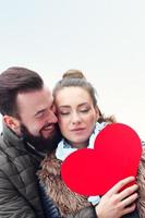 Romantic couple holding heart photo