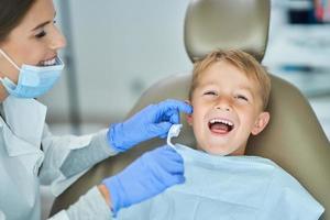 Little boy and female dentist in the dentists office photo