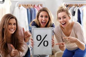 Group of happy friends shopping in store photo