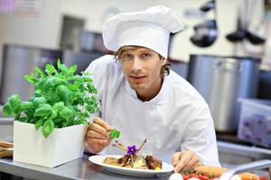 Busy chef at work in the restaurant kitchen photo