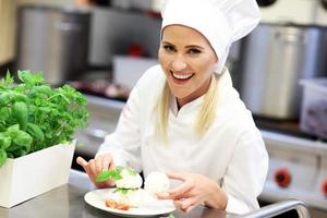 Busy chef at work in the restaurant kitchen photo