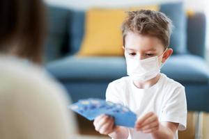 Mother and child playing together at home isolation during coronavirus pandemic photo