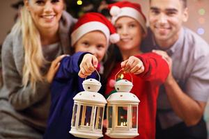 Happy family posing with Christmas lanterns photo