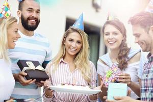 Group of friends having fun at birthday party photo