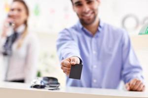 Happy receptionist working in hotel photo