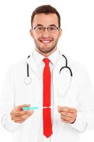 Doctor holding syringe photo