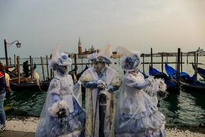 Unidentified people wearing carnival masks at the Venice Carnival in Venice, Italy, circa February 2022 photo