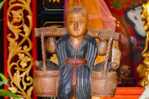 Buddhist sculptures in a temple in Bangkok, Thailand, circa May 2022 photo