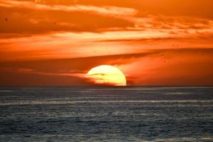 Sunset over the ocean photo