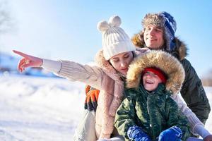 Nice happy family having fun on winter snow photo