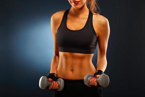 Woman lifting dumbells photo