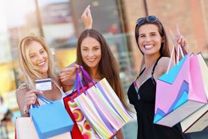 Happy girl friends shopping in mall photo