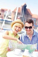 Young couple pointing at map photo