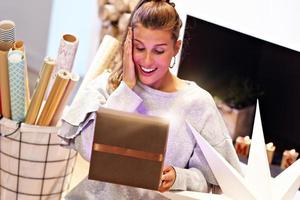 Adult woman at home wrapping Christmas presents photo