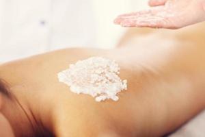 Beautiful woman having exfoliation treatment in spa photo